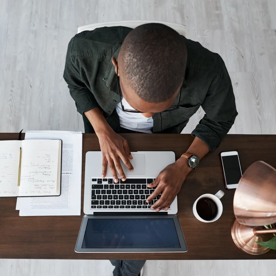Technology professional working with software at a laptop